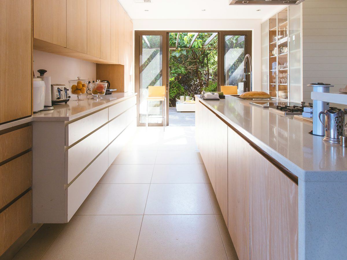 Empty, spotless galley kitchen ready for a new tenant